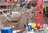 A bustling construction site in Hamburg with workers and equipment actively engaged in building tasks.